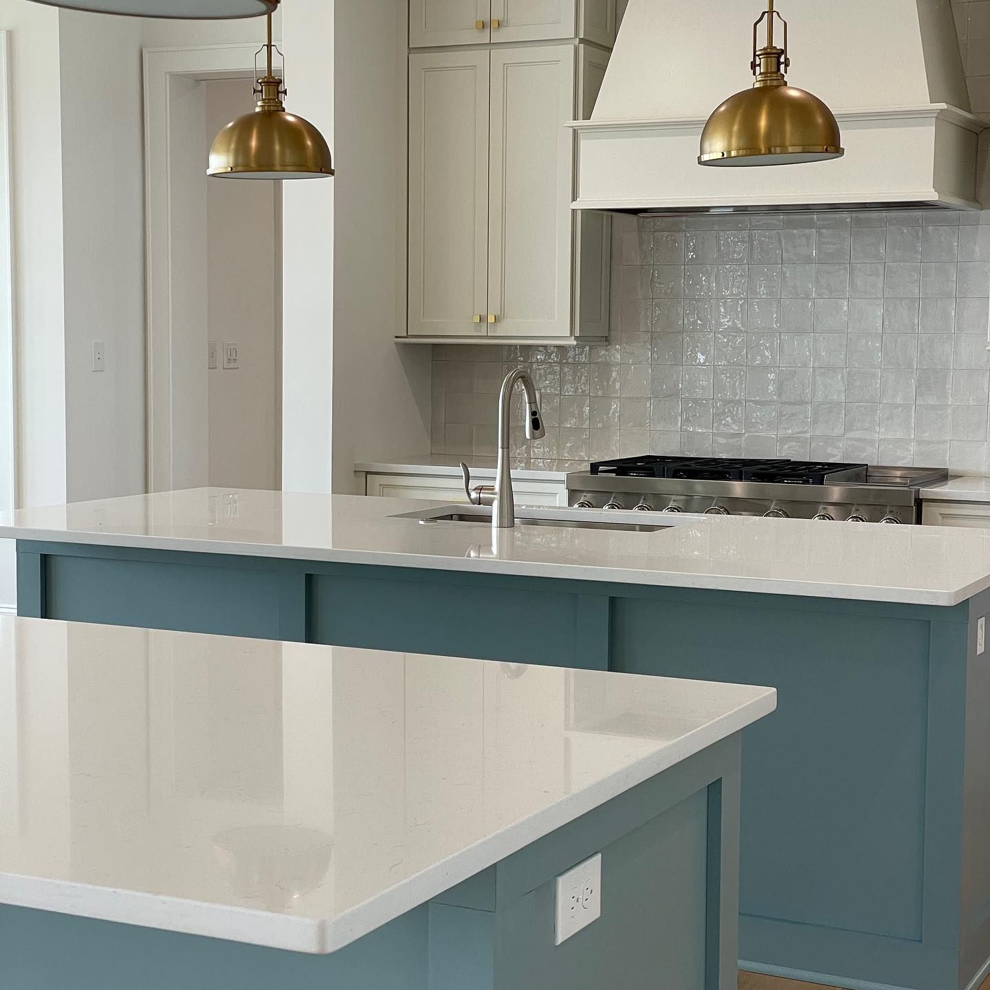 A kitchen with blue cabinets and white counter tops