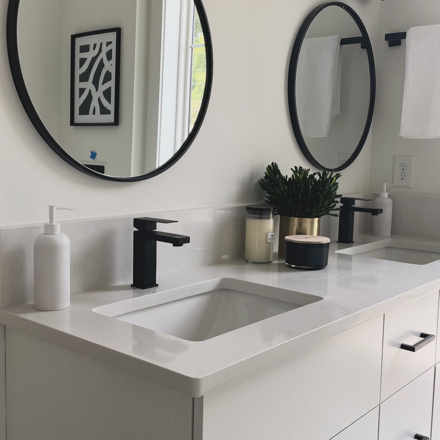 A bathroom with two sinks and two mirrors