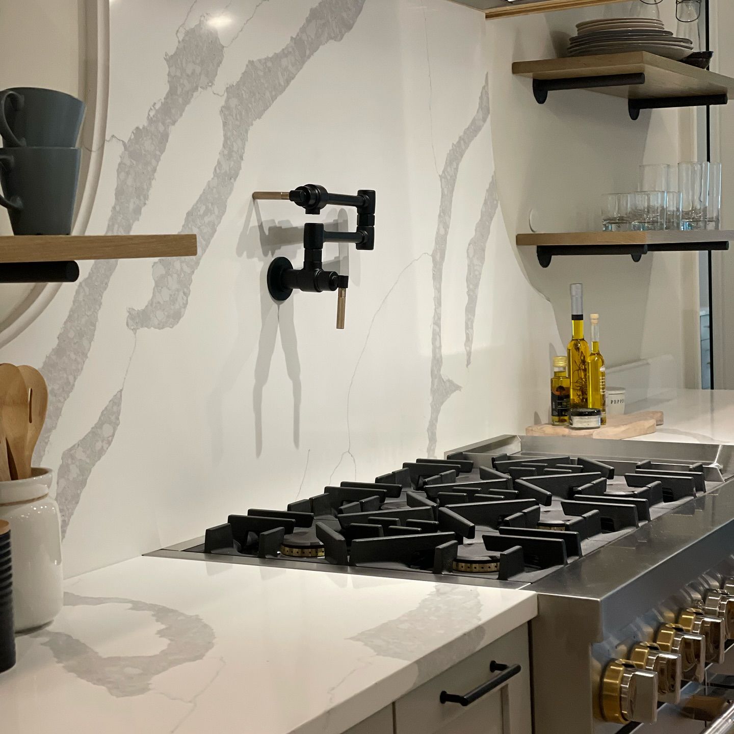 A kitchen with a stove top oven and shelves