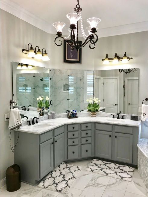 A bathroom with two sinks and a large mirror
