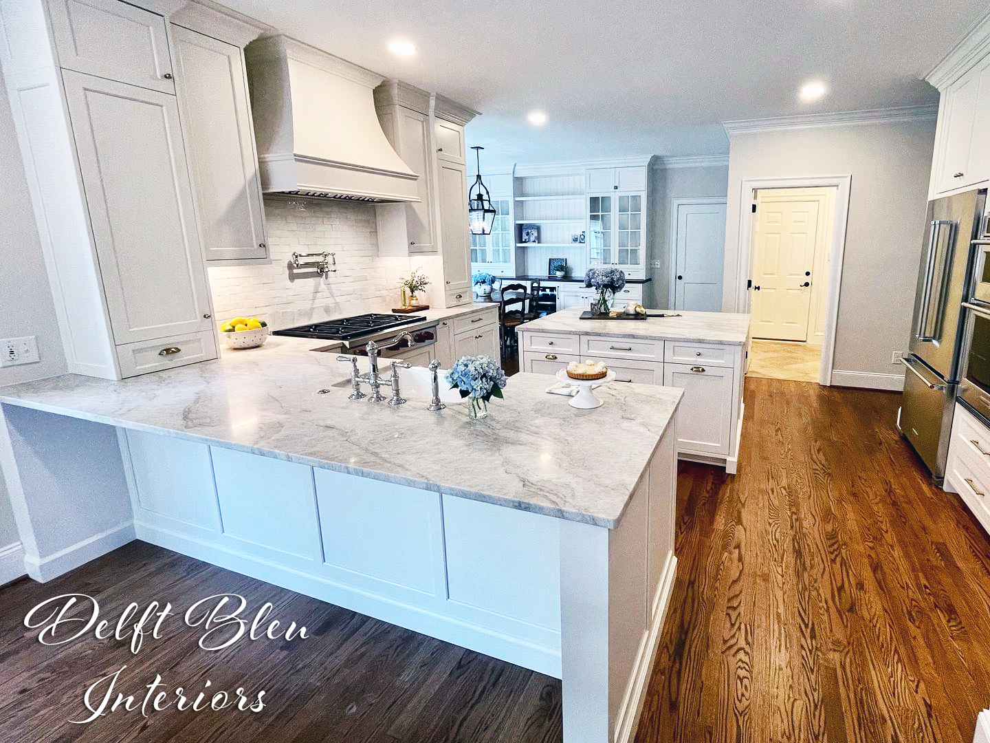A kitchen with white cabinets and granite counter tops.