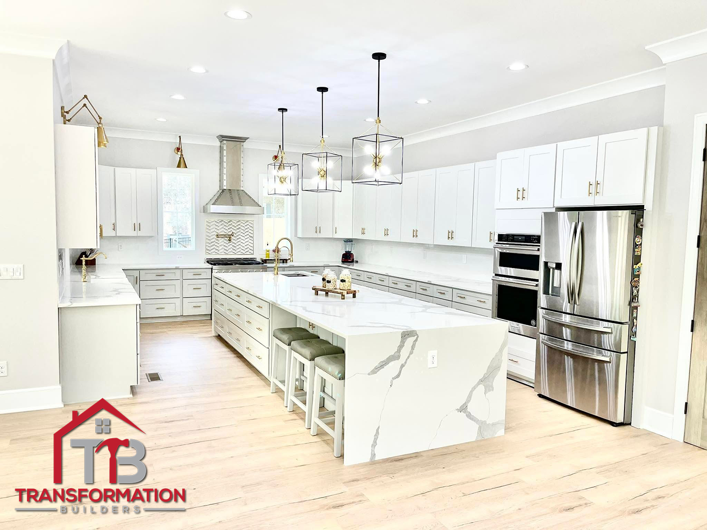 A large kitchen with white cabinets and stainless steel appliances.