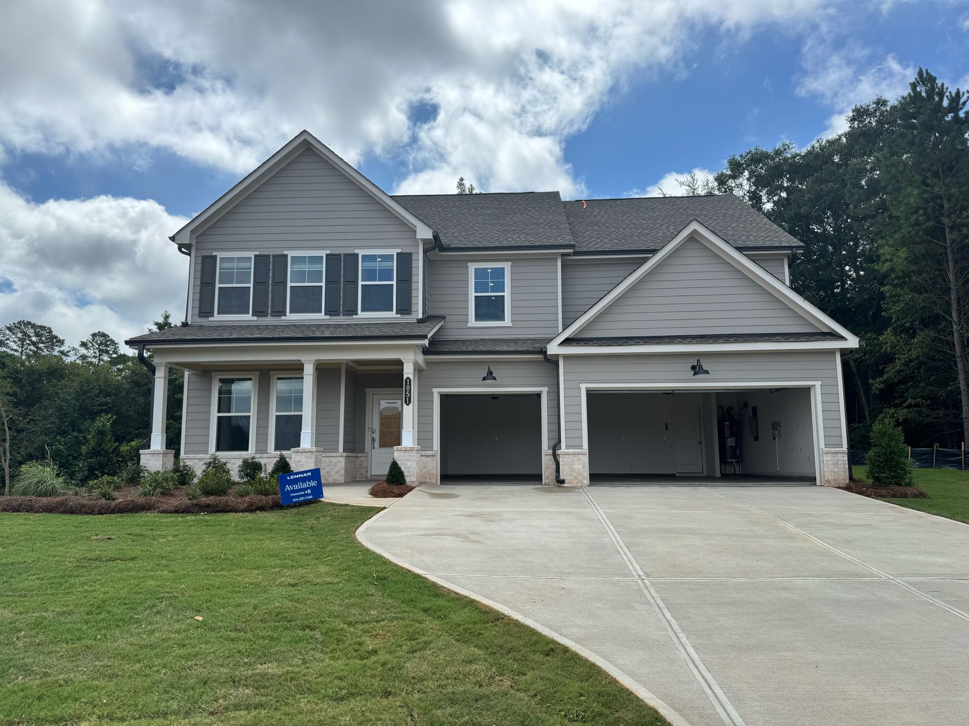 A large house with a concrete driveway in front of it