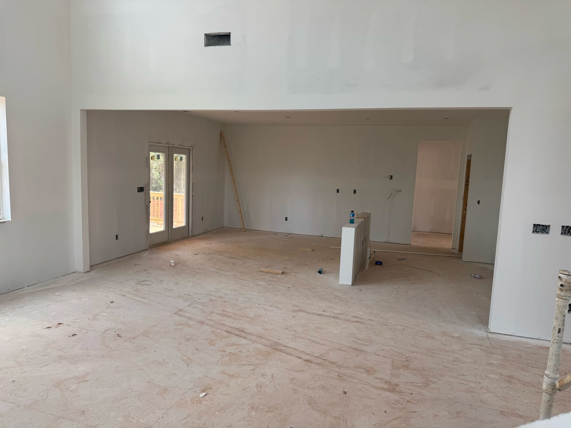 An empty room with white walls and a wooden floor