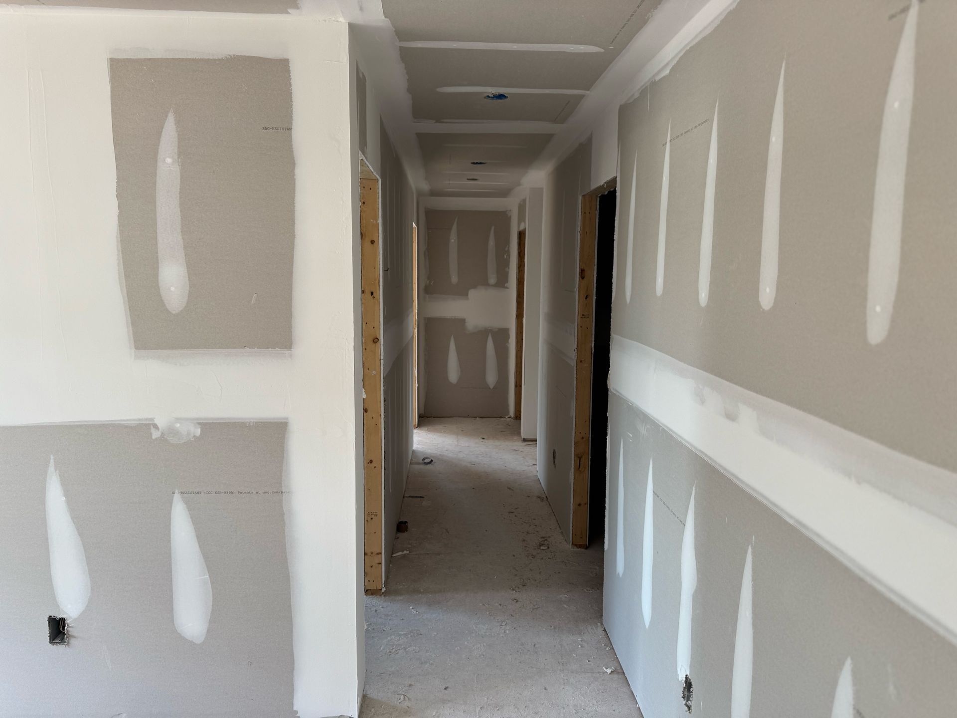 A long hallway with a lot of drywall on the walls