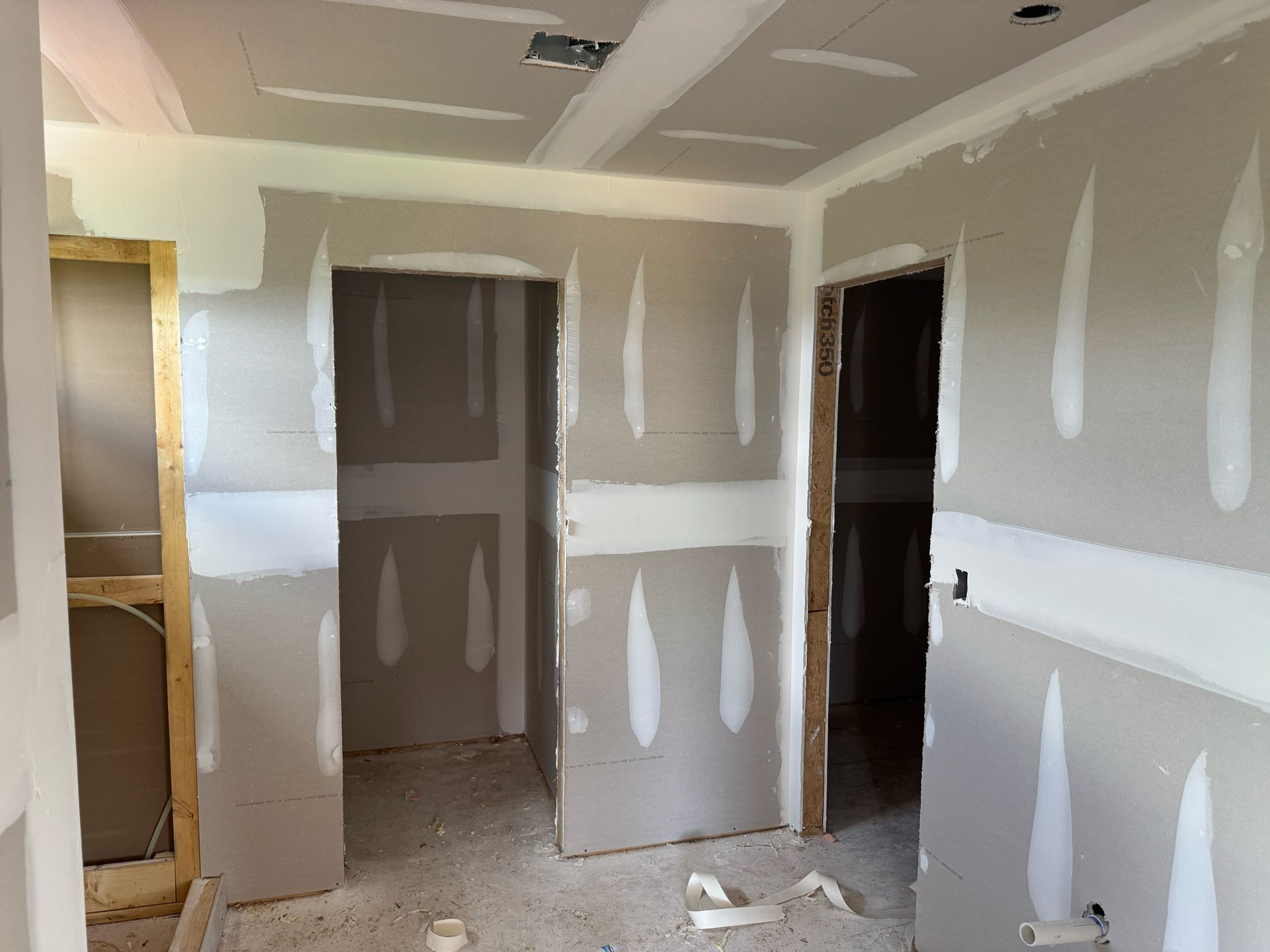 A room with a lot of drywall on the walls