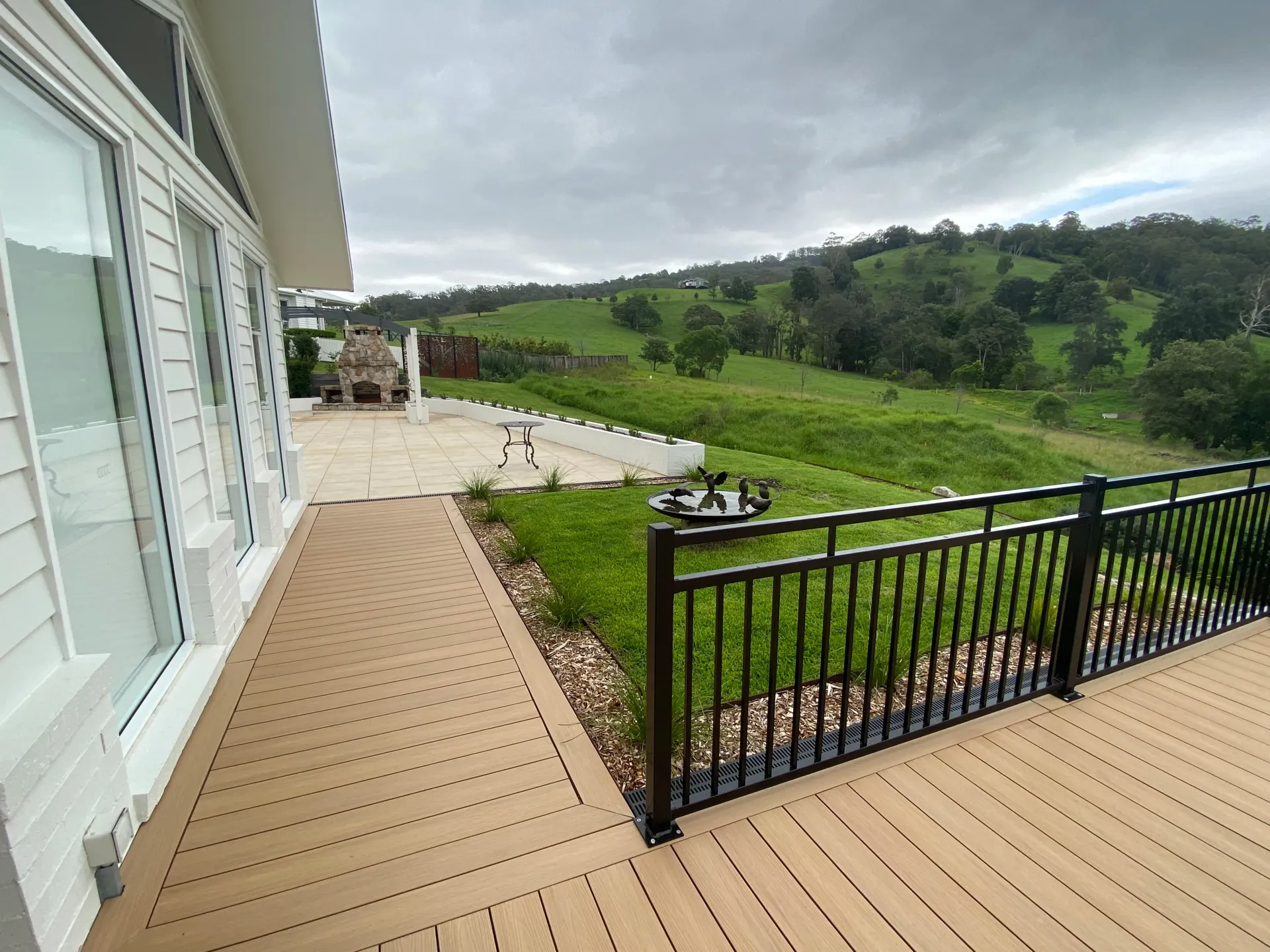 Wooden Deck Extending from A House with Large Windows — CAW Services in Badagarang, NSW