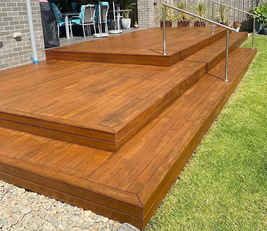 A Wooden Deck with Three Levels And Steel Handrail — CAW Services in Badagarang, NSW