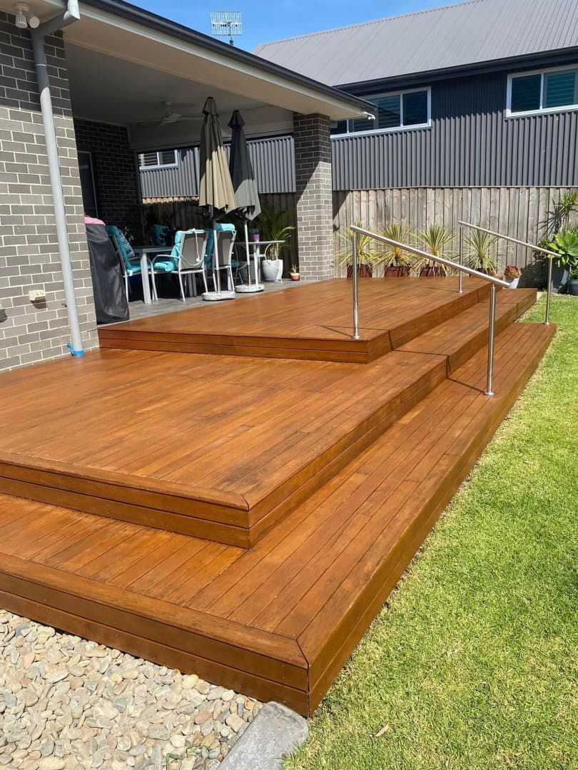 Wooden Deck With Steps, Handrail, and Covered Patio in a Grassy Backyard — CAW Services in Badagarang, NSW