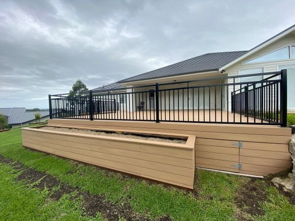 Deck with Black Railing and Composite Siding and Planter Box — CAW Services in Badagarang, NSW