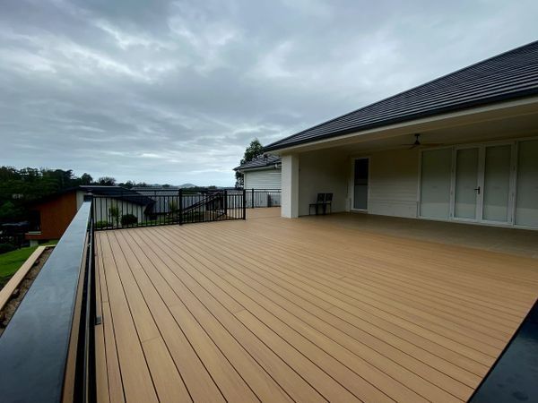 Spacious Outdoor Deck with Brown Composite Boards — CAW Services in Badagarang, NSW