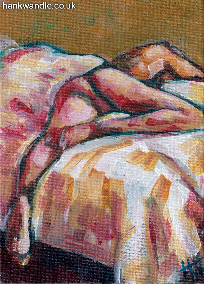 a male nude lying face down on a bed