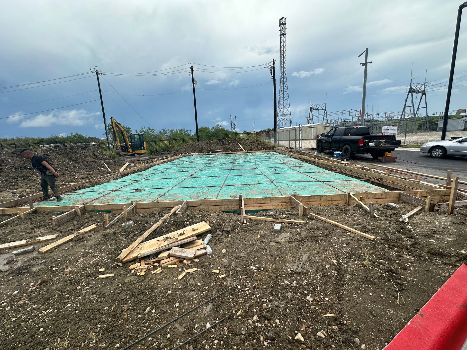 A construction site with a truck parked in the background.