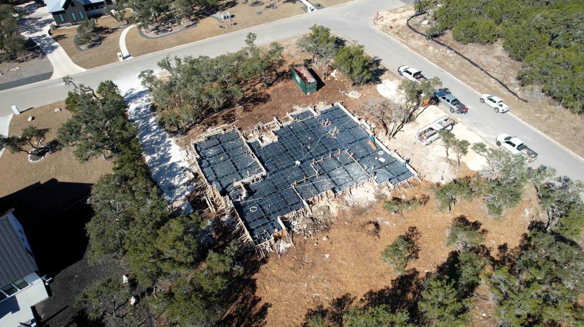 An aerial view of a house under construction in a residential area