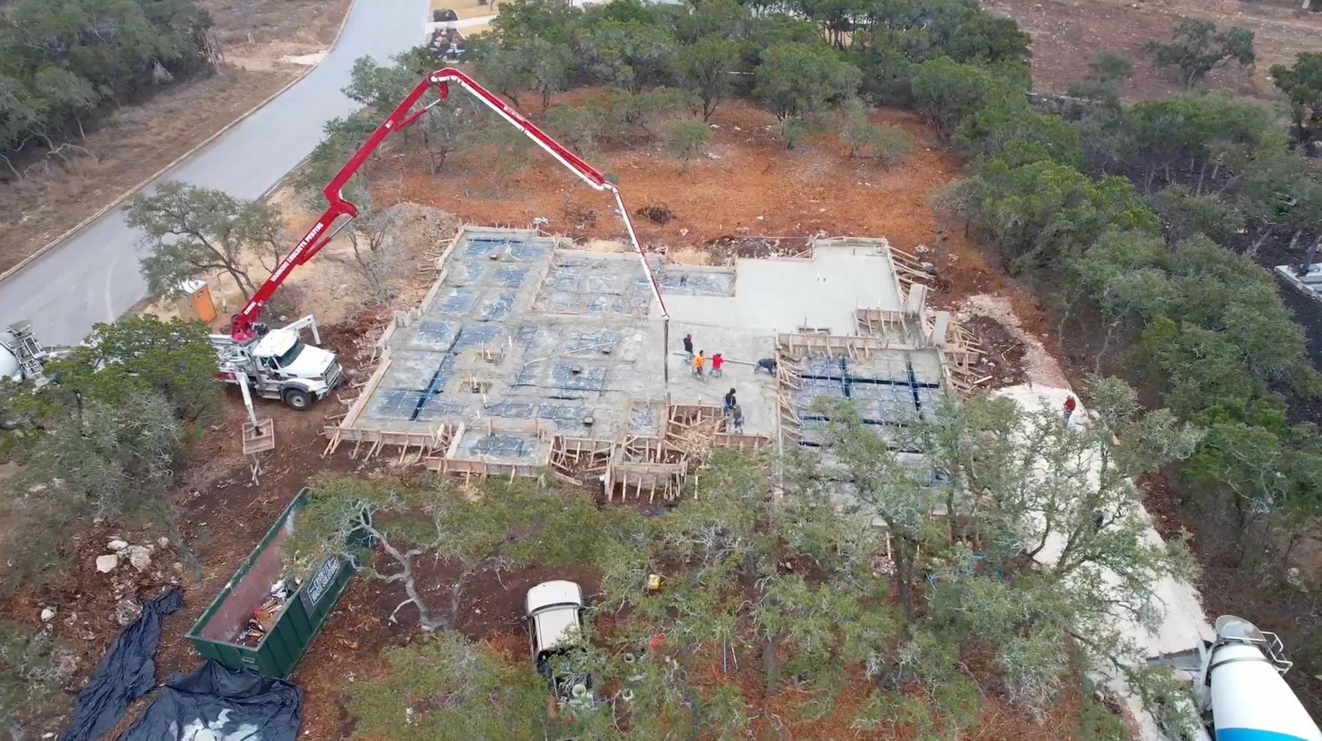 An aerial view of a construction site with a concrete pump.
