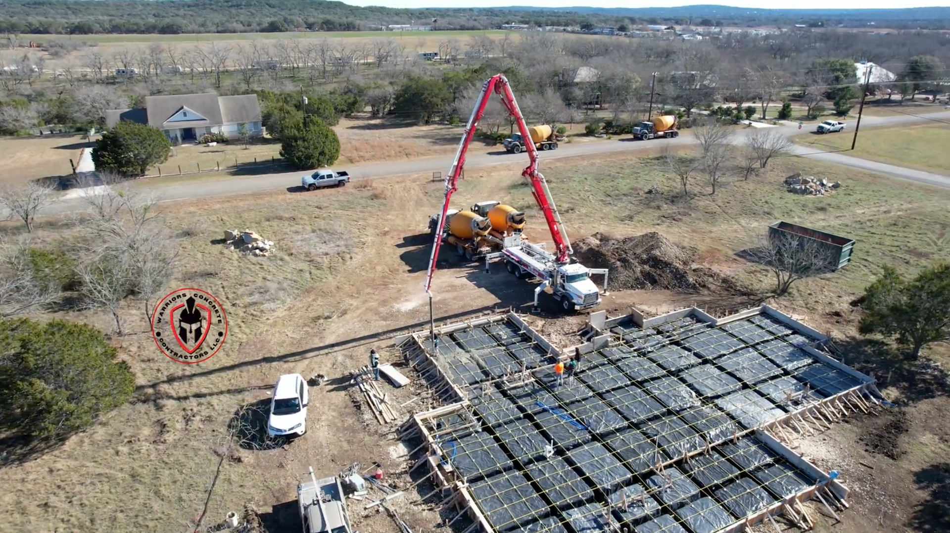 An aerial view of a construction site with a concrete pump.