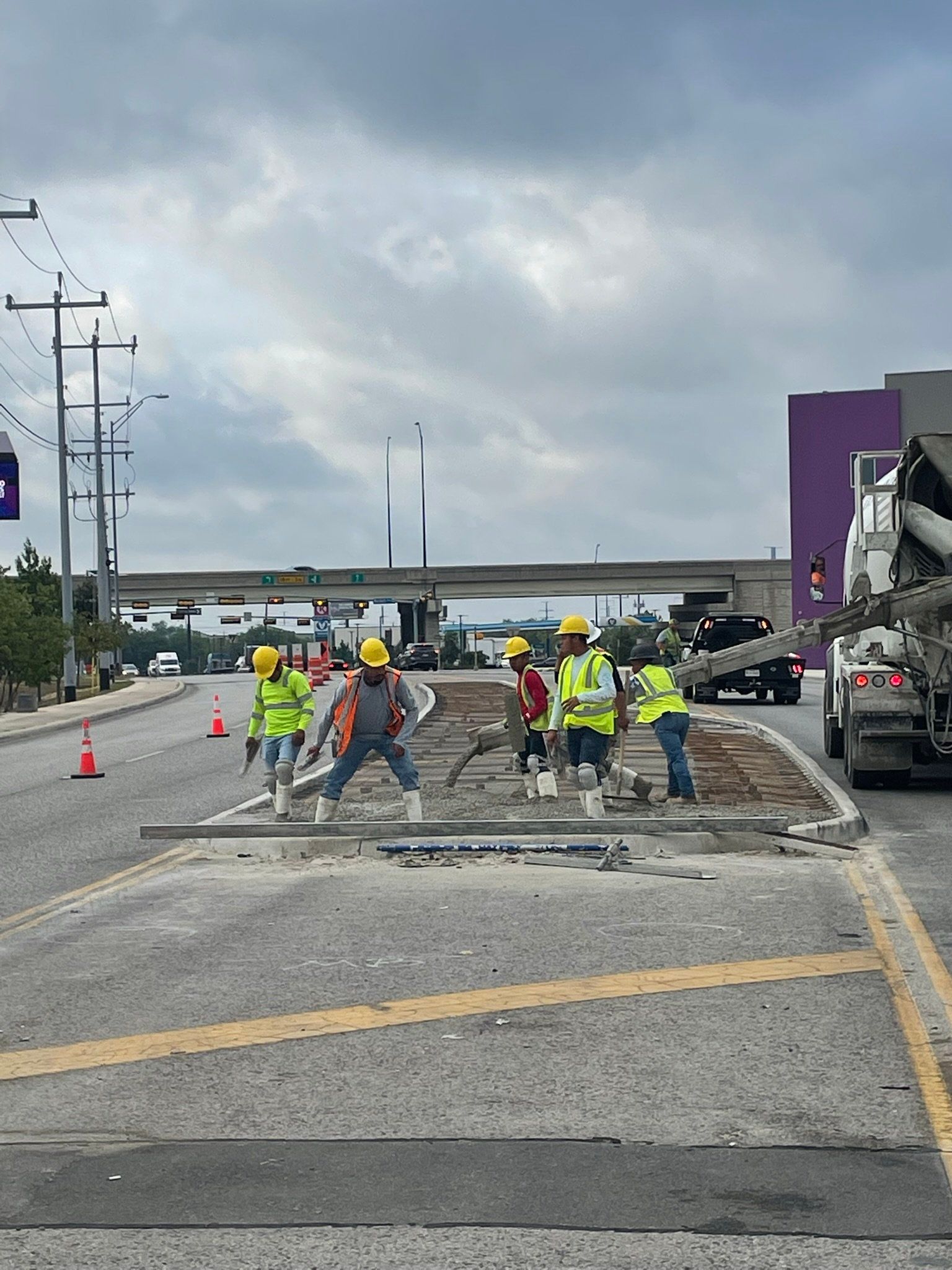 A group of construction workers are working on a road.