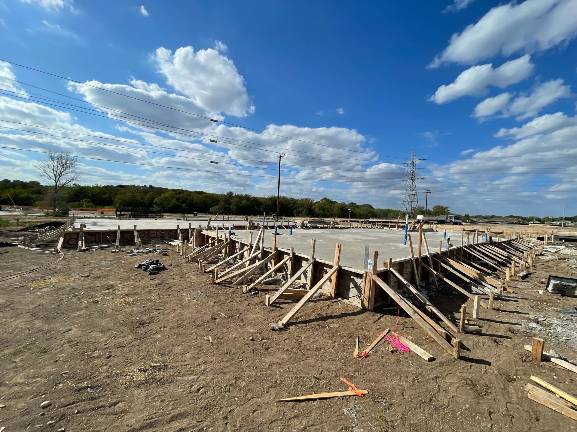 A construction site with a blue sky and clouds in the background.