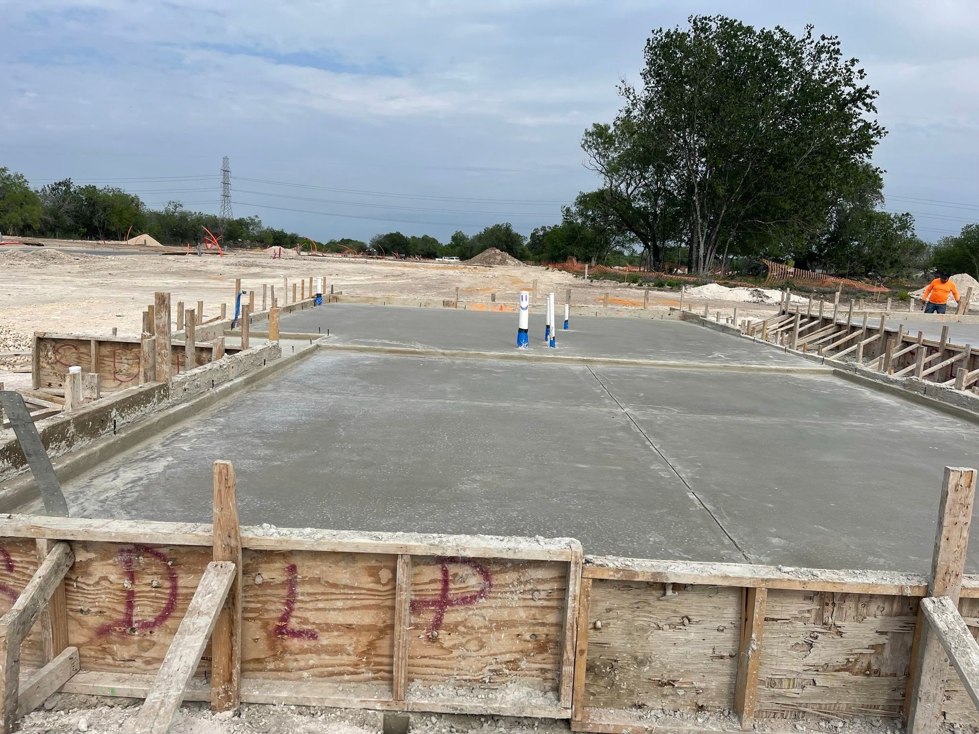 A concrete road is being built in a construction site.