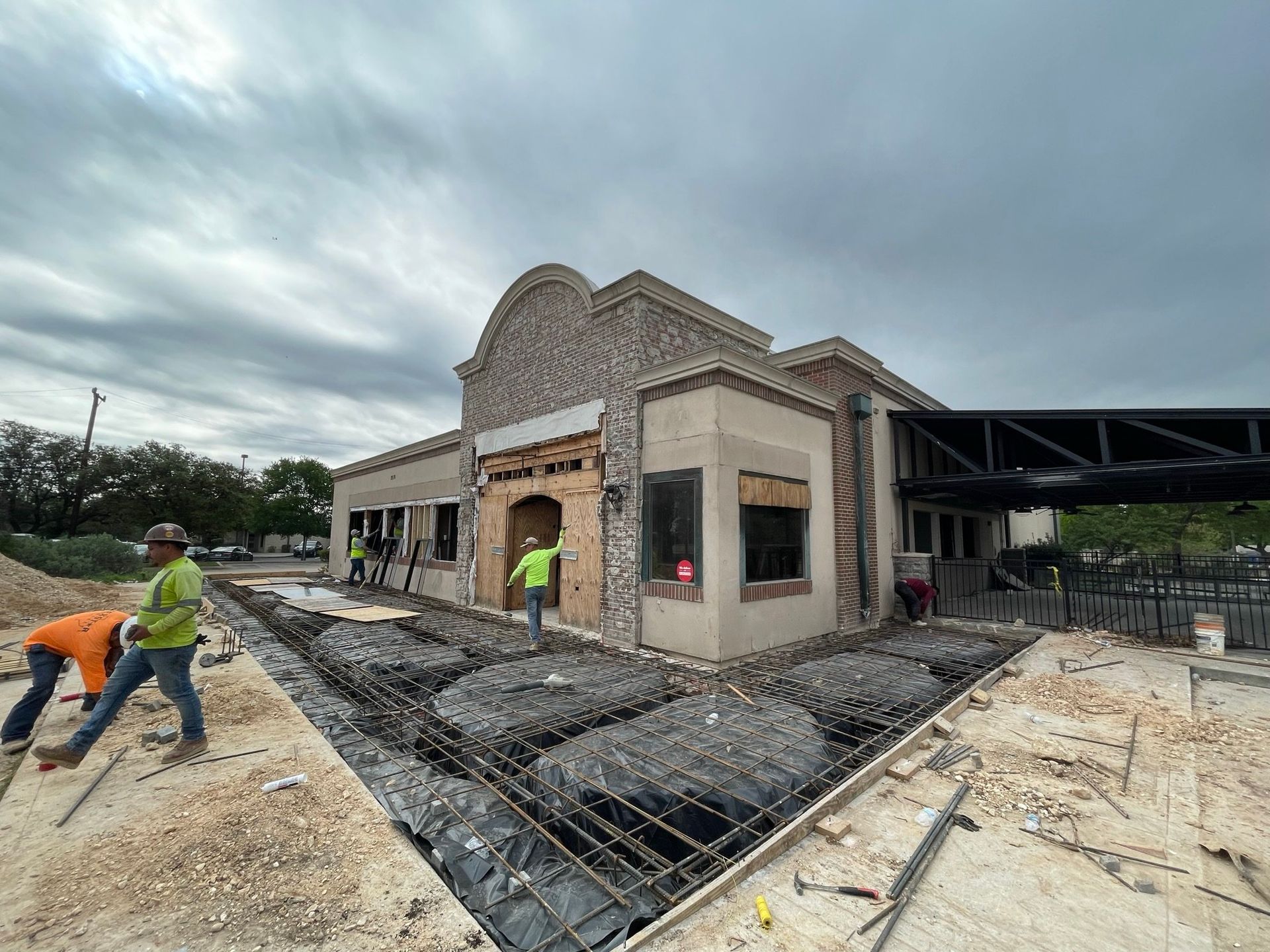 A group of construction workers are working on a building under construction.