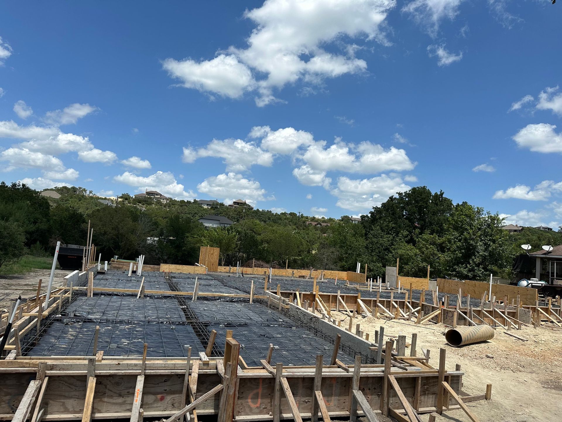 A construction site with a blue sky and white clouds in the background.