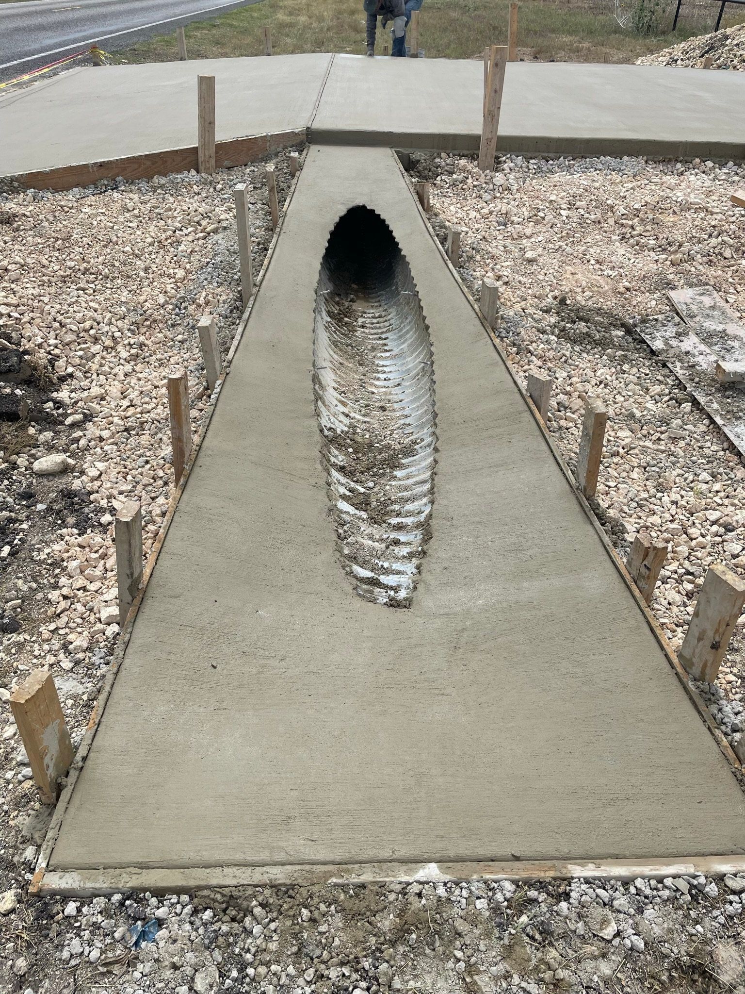 A concrete walkway with a hole in the middle of it
