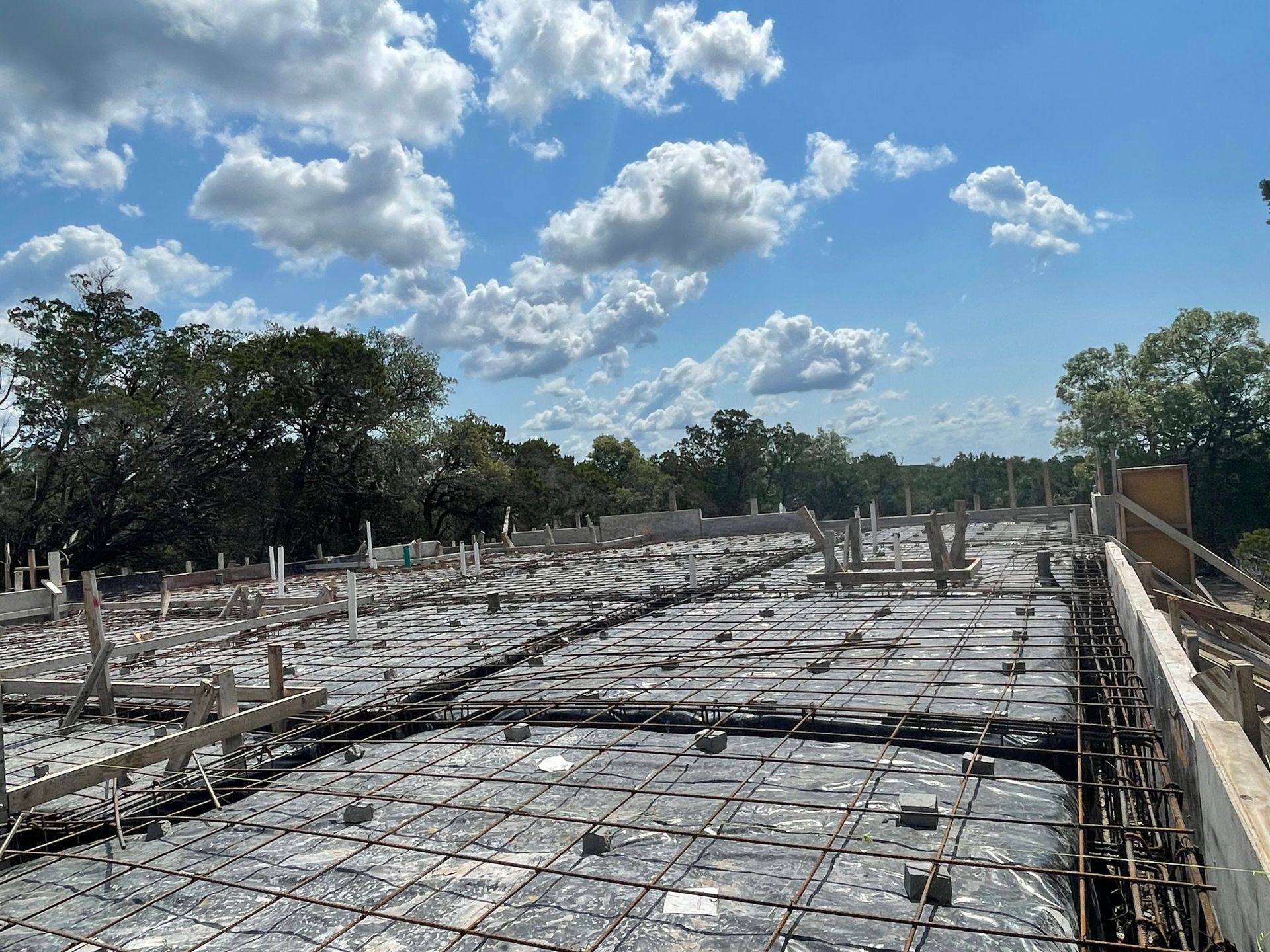 A construction site with a blue sky and clouds in the background.