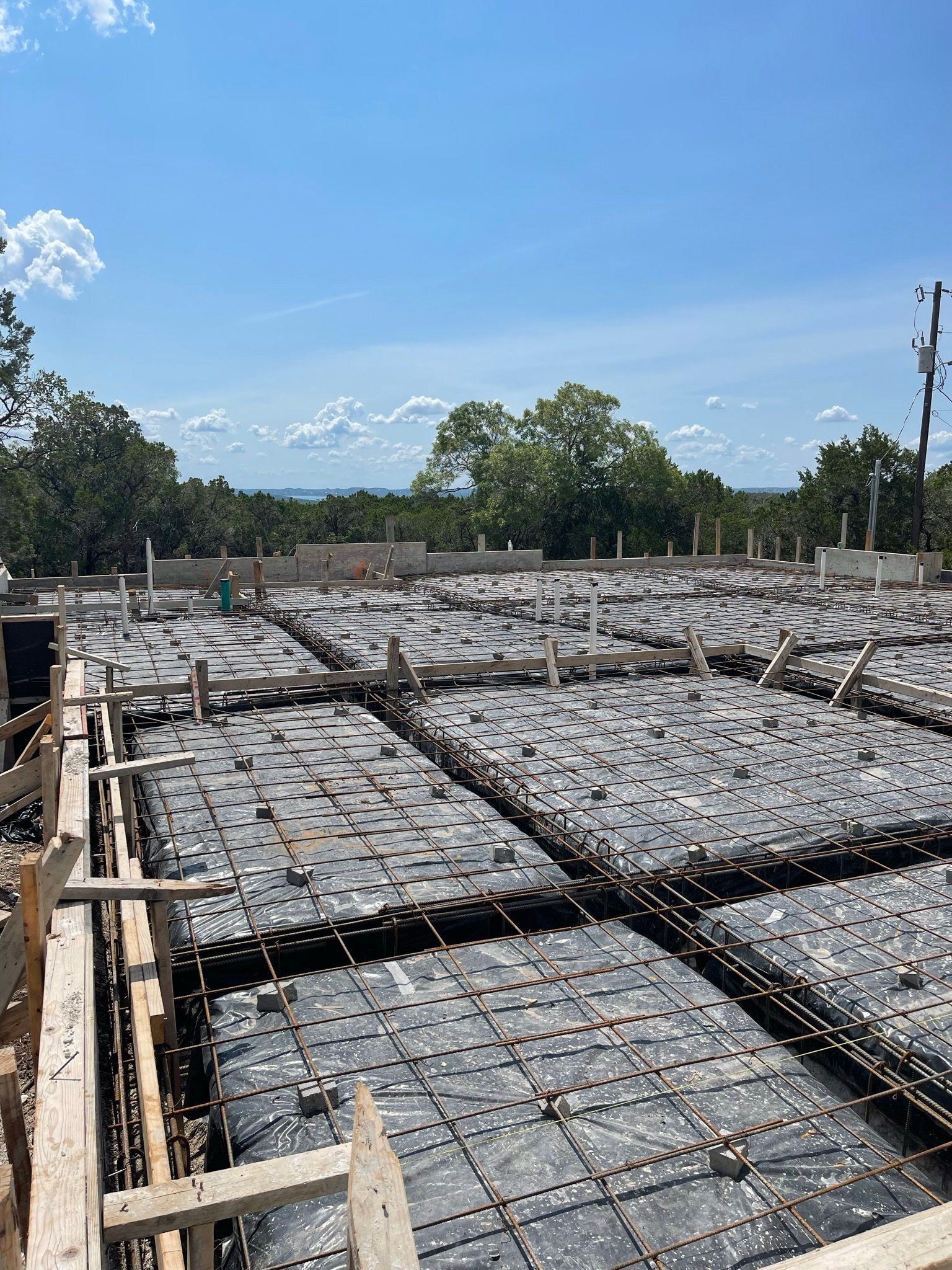 A large concrete slab is being built on a construction site.