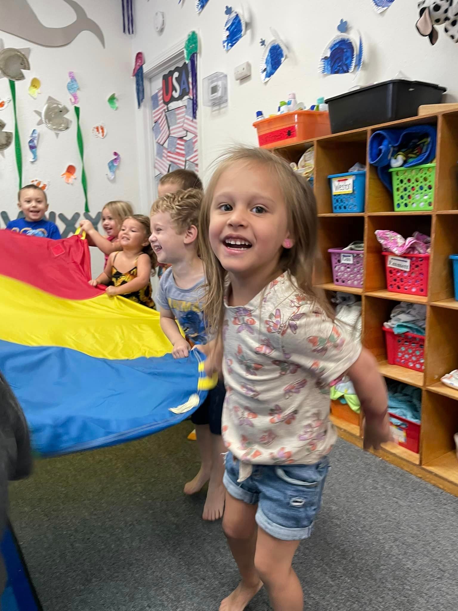 happy children holding colorful flag