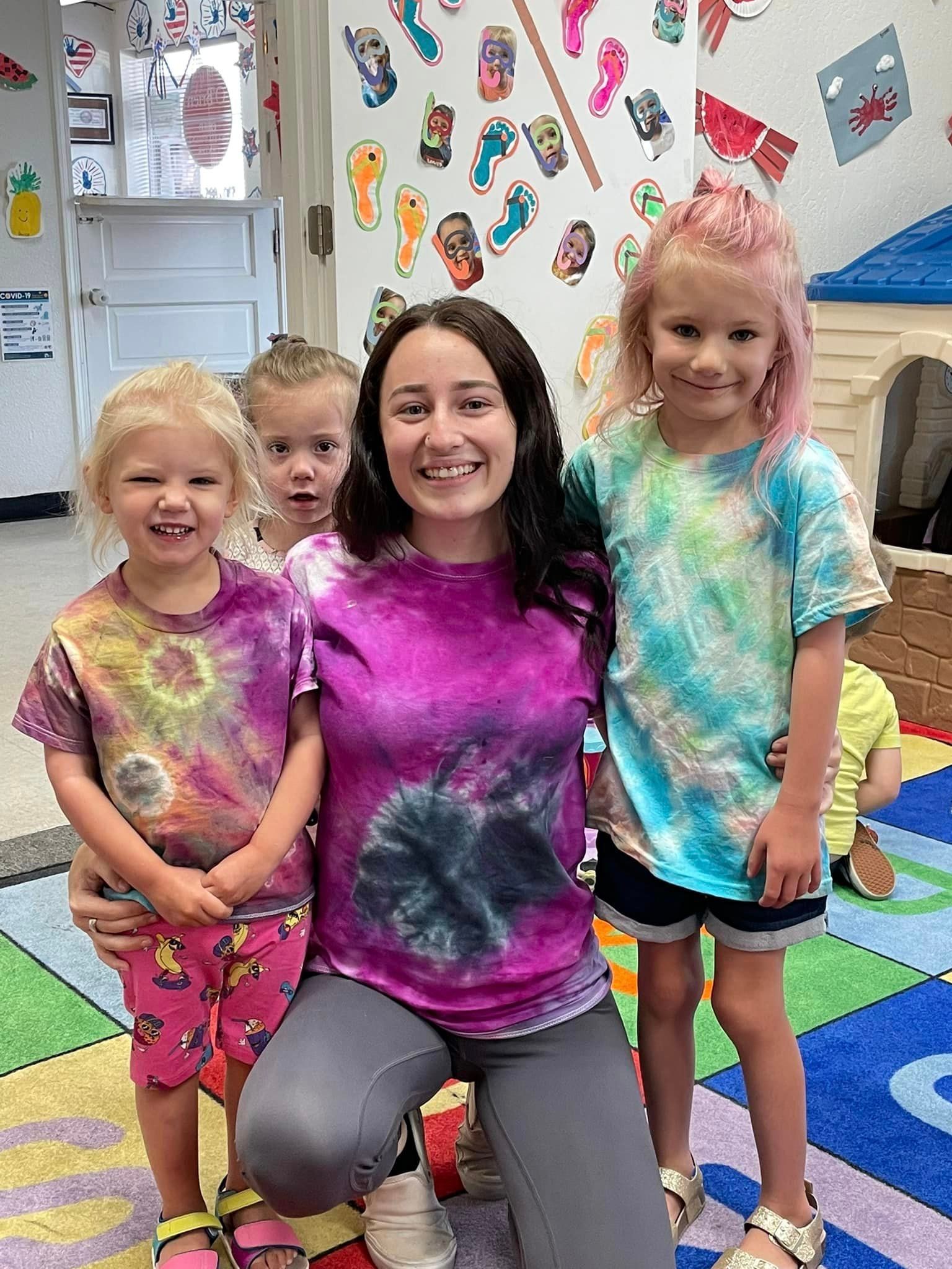 teacher with children showing their shirt project