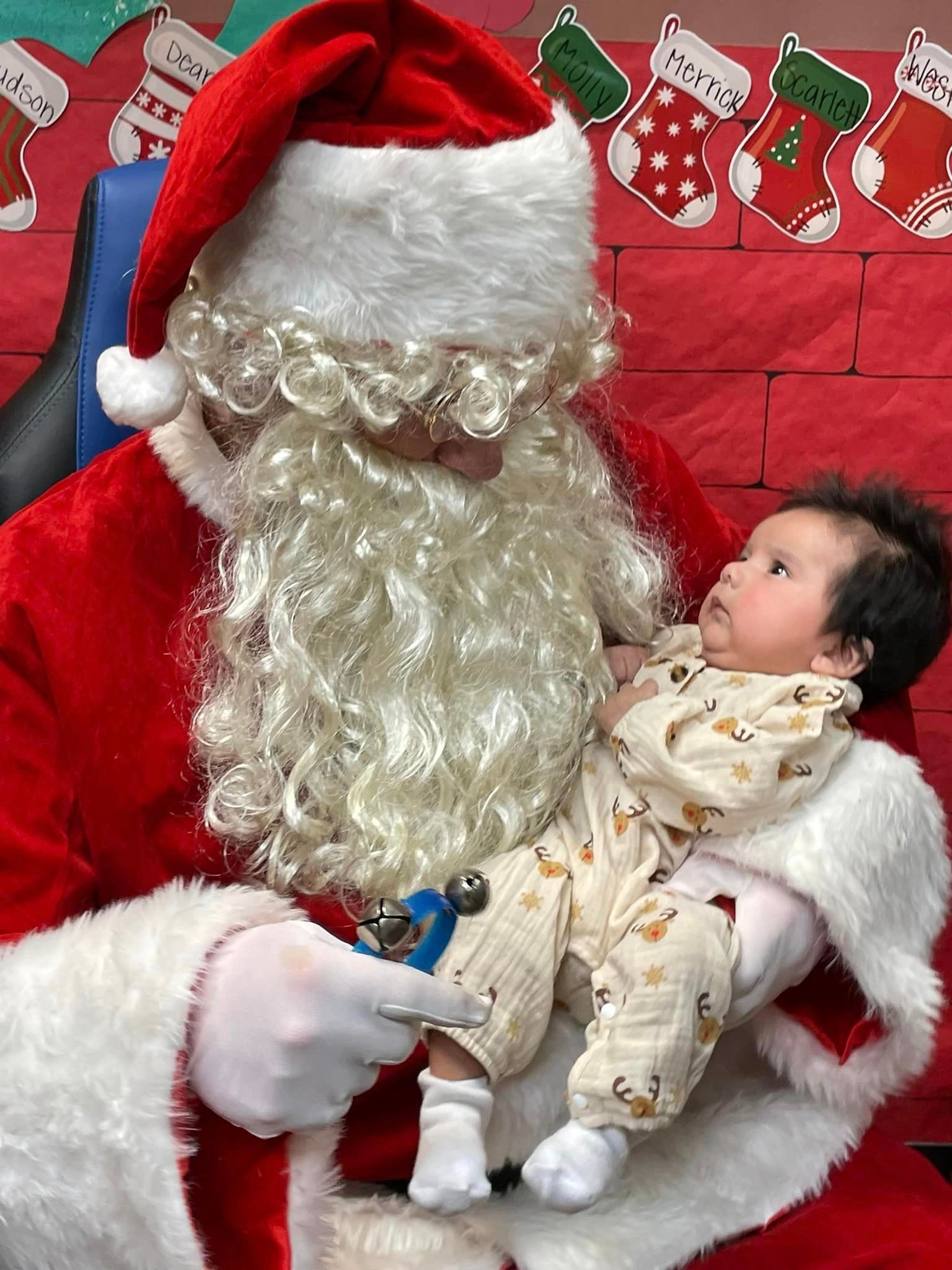 infant looking at santa claus