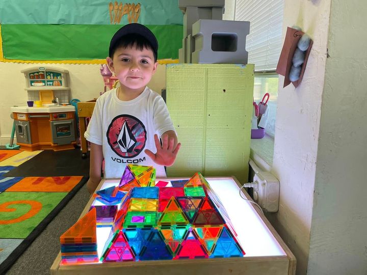 boy in front of cubes with colorful lights