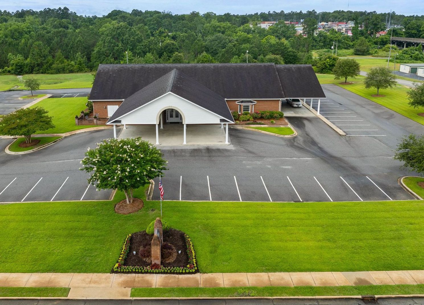 A funeral home with a black awning over the door