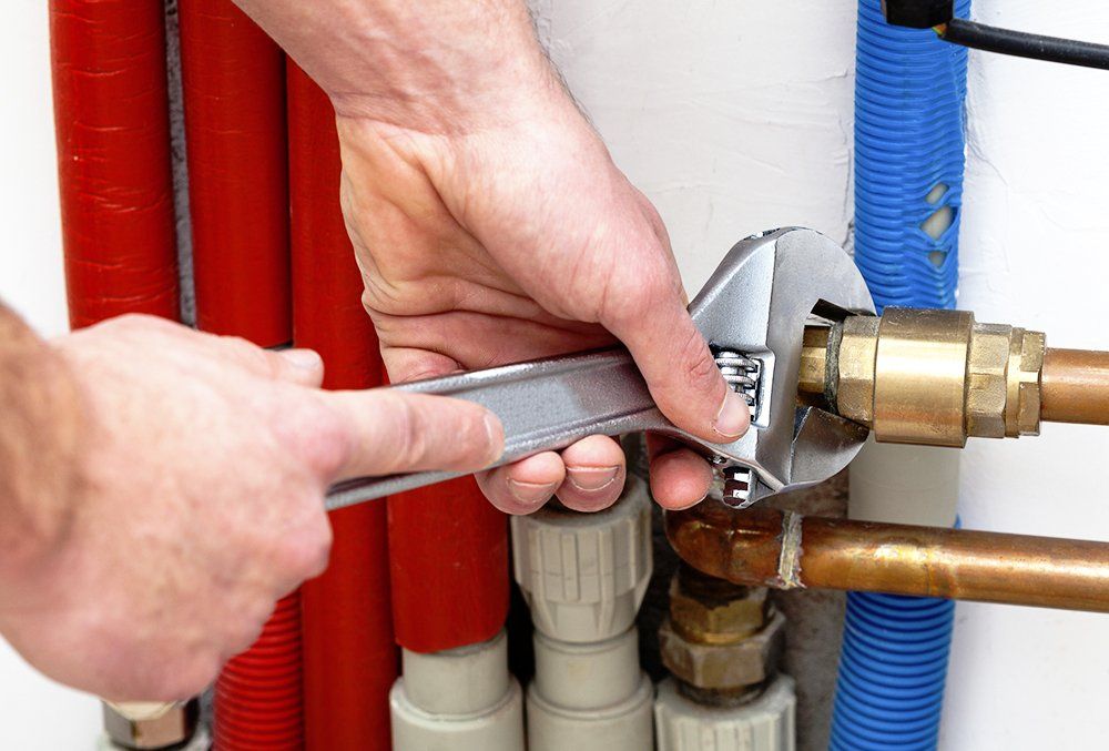 Worker repairing water pipes - Residential plumber in Lynn, MA