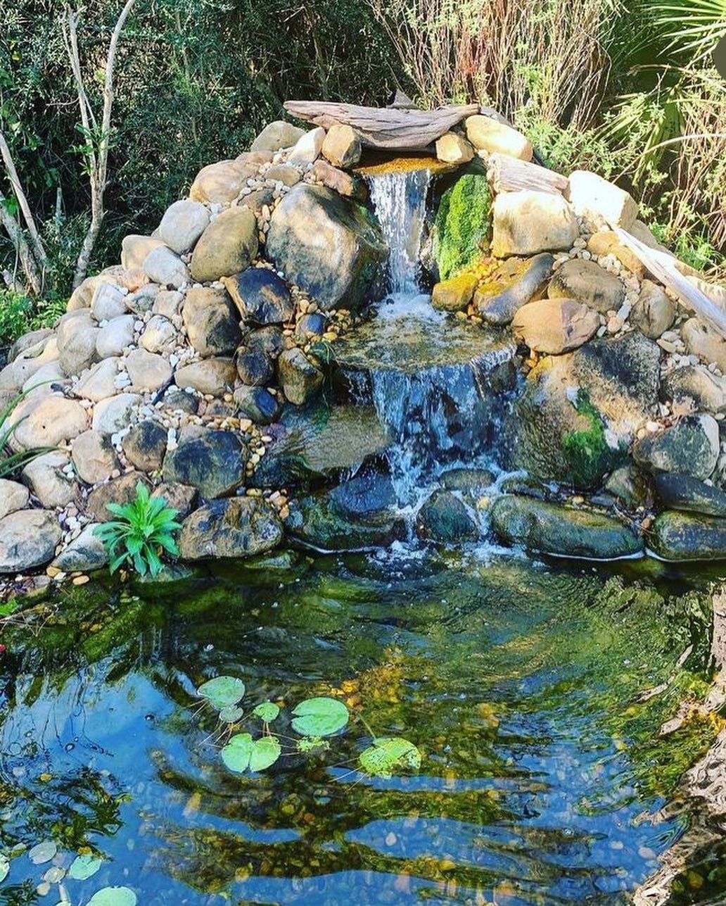 Two men are standing in a pile of rocks.