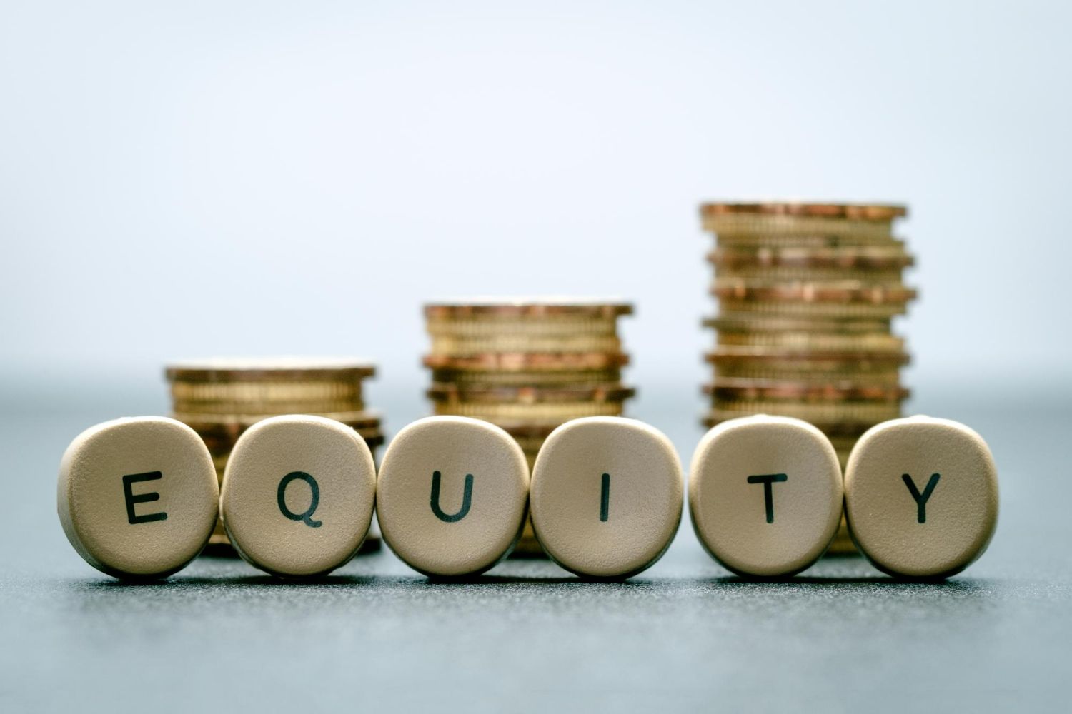 Stacks of gold coins behind the word 