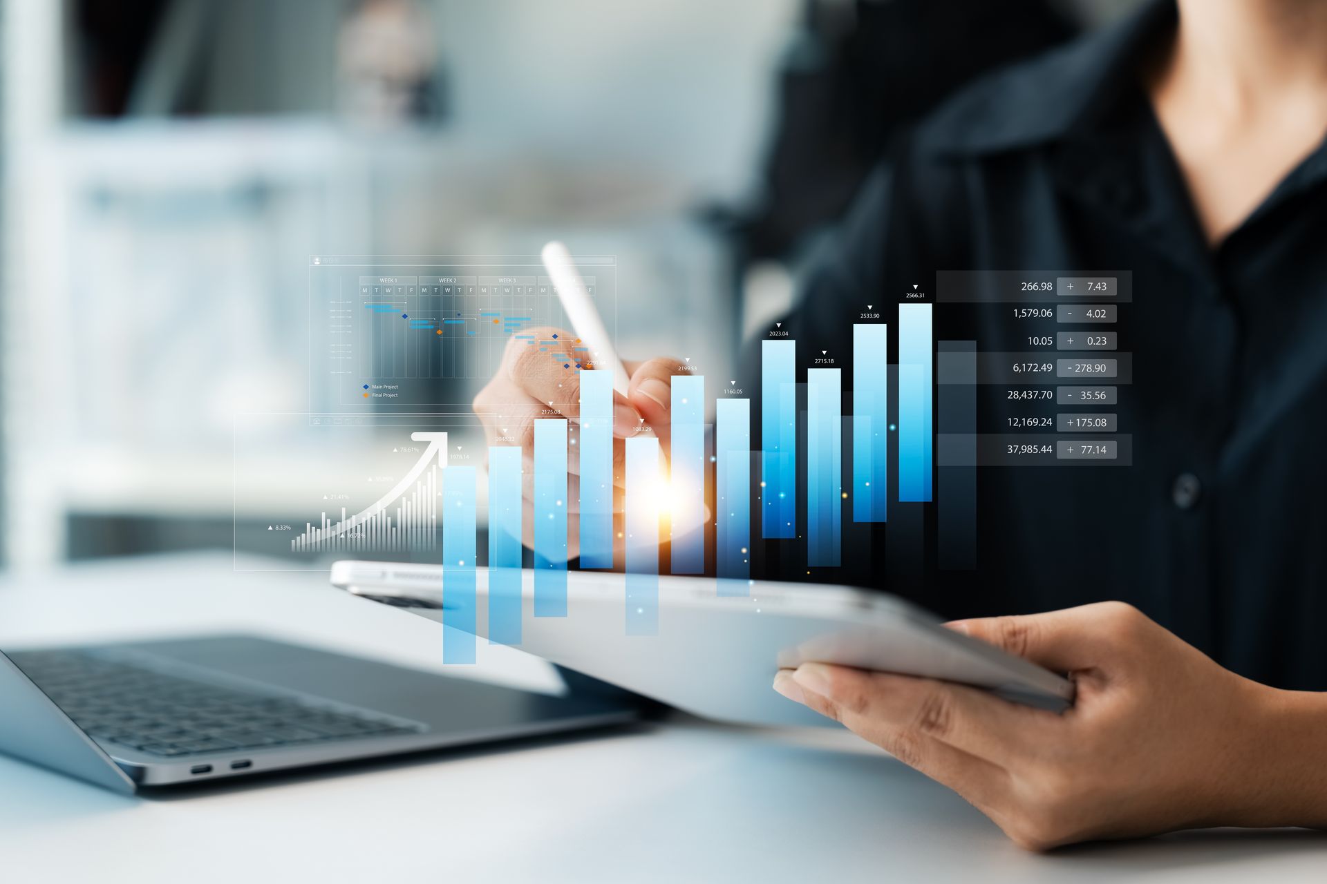 Person analyzing data on tablet, with rising blue bar graph overlay and laptop.