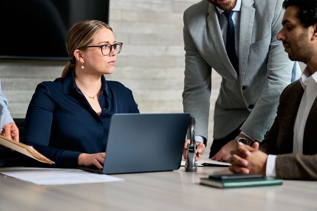 A man and a woman are sitting at a table talking to each other.