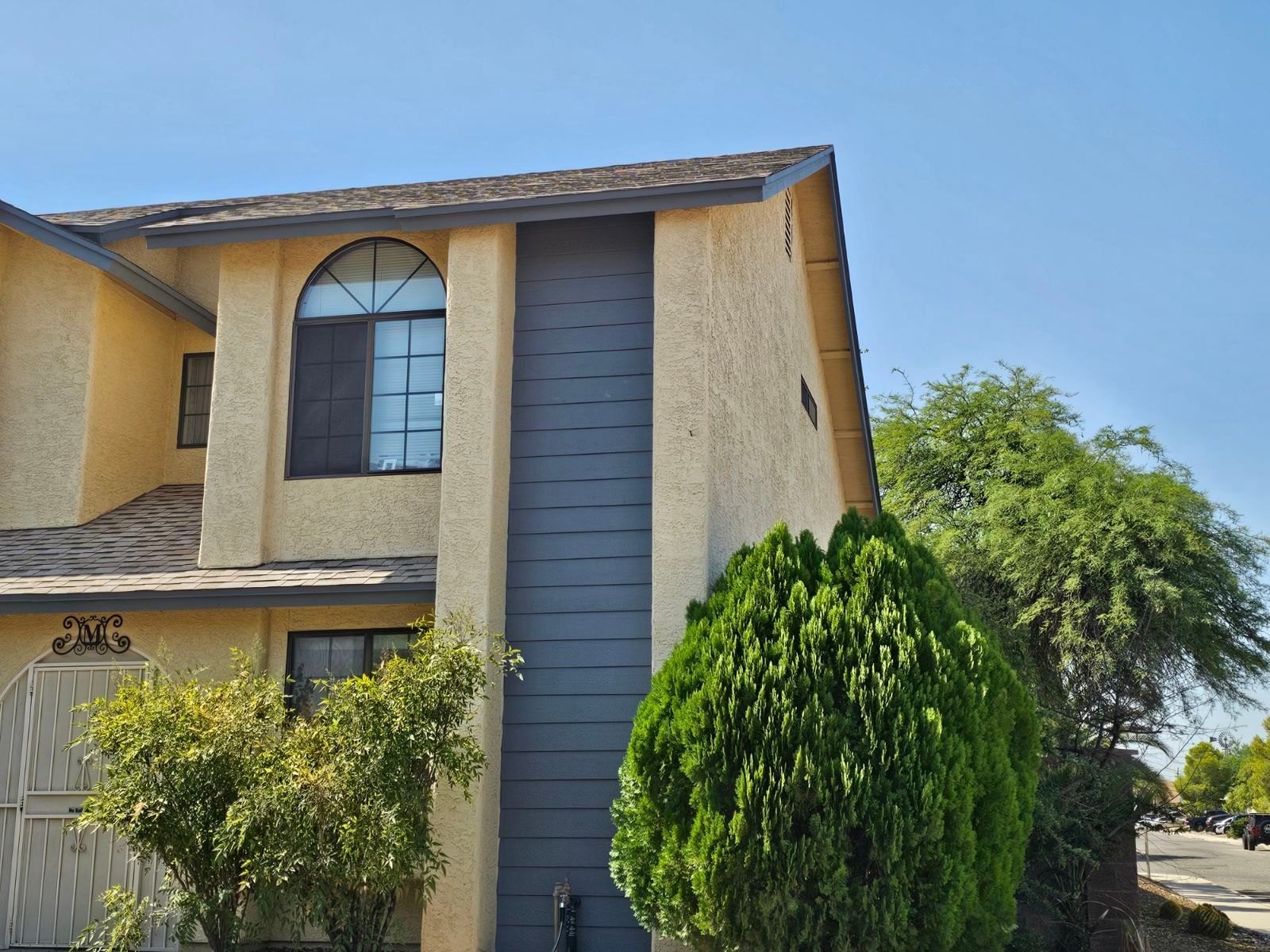 A house with a few trees in front of it