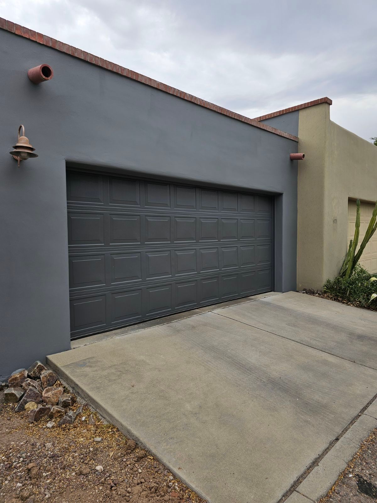 A large garage door is sitting in front of a house.