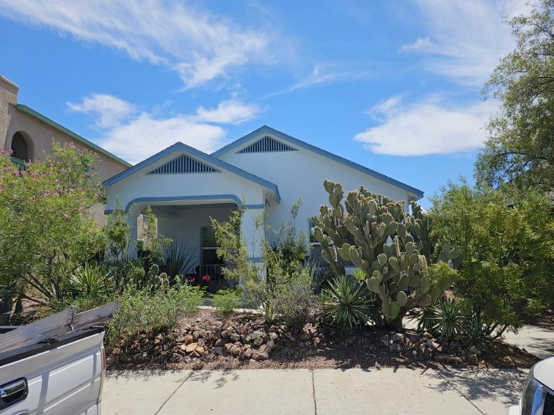 A white house with a truck parked in front of it