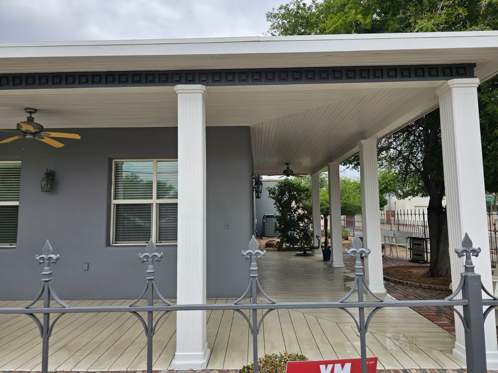 The front of a house with a porch and a ceiling fan.