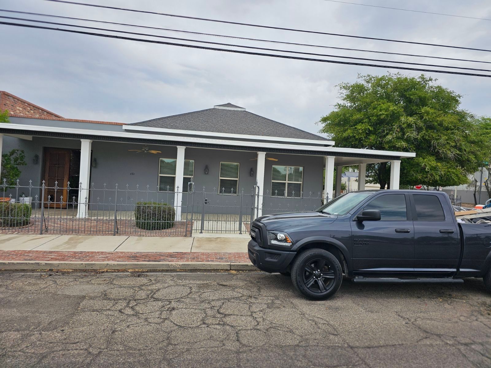A black truck is parked in front of a house.