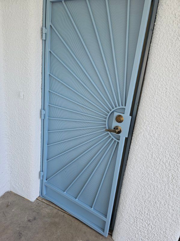 A blue door with a sunburst design on it