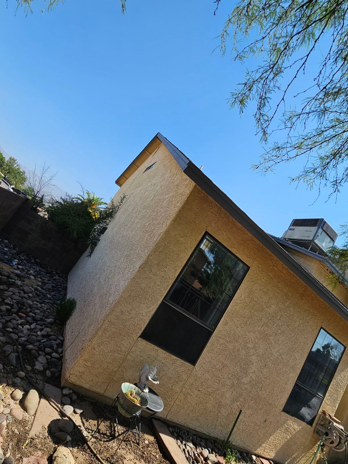 A small house with a blue sky in the background.