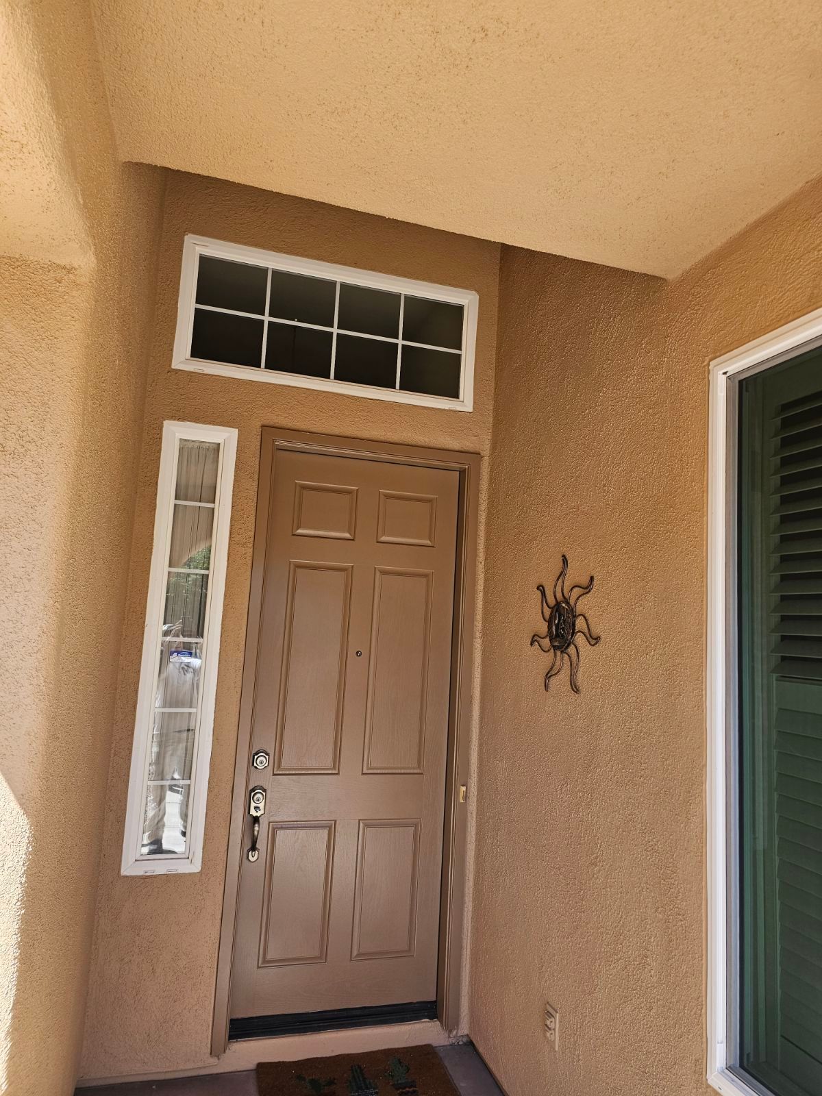 The front door of a house with a spider on it