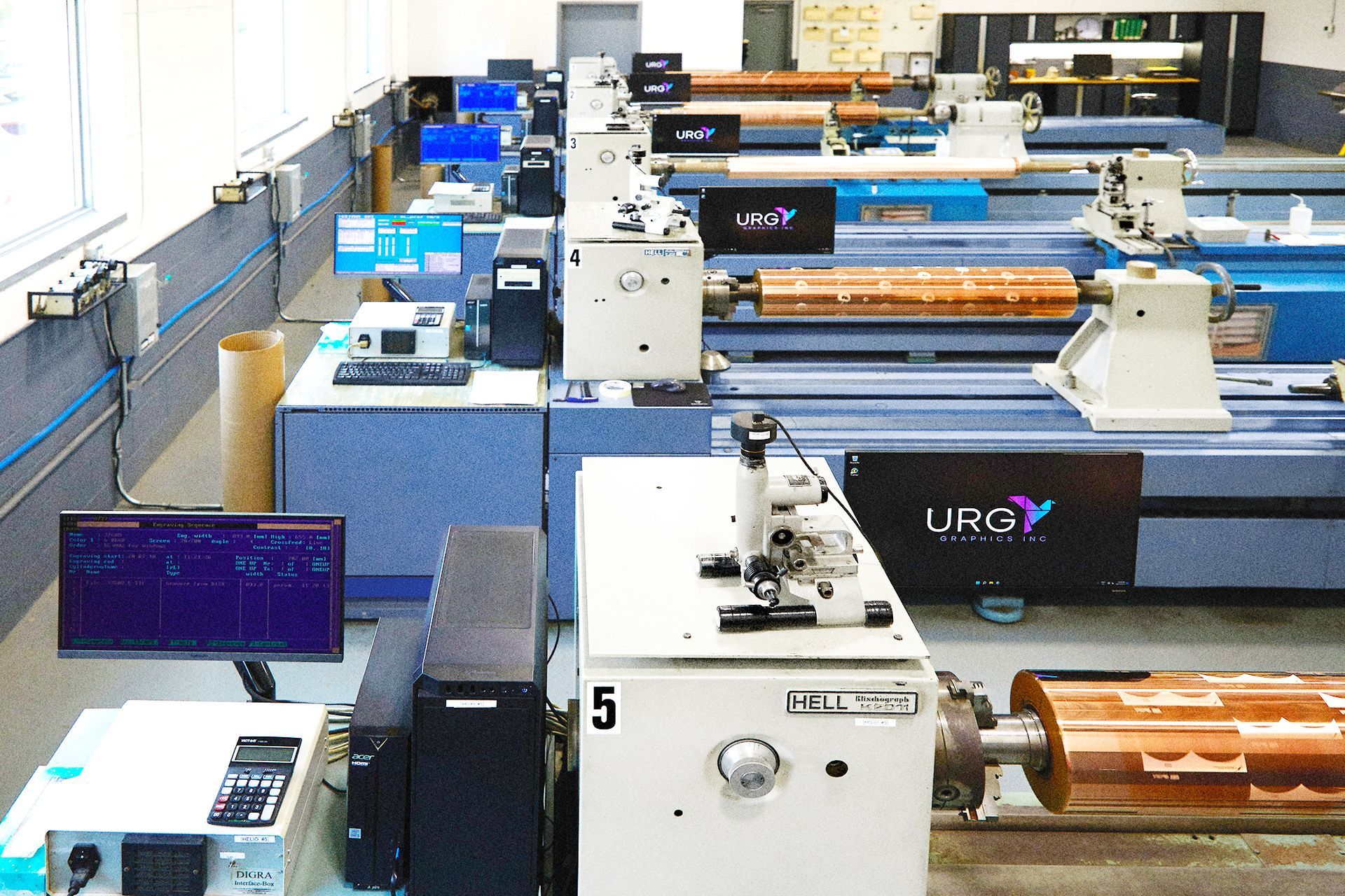 A row of ur3y machines are lined up in a room