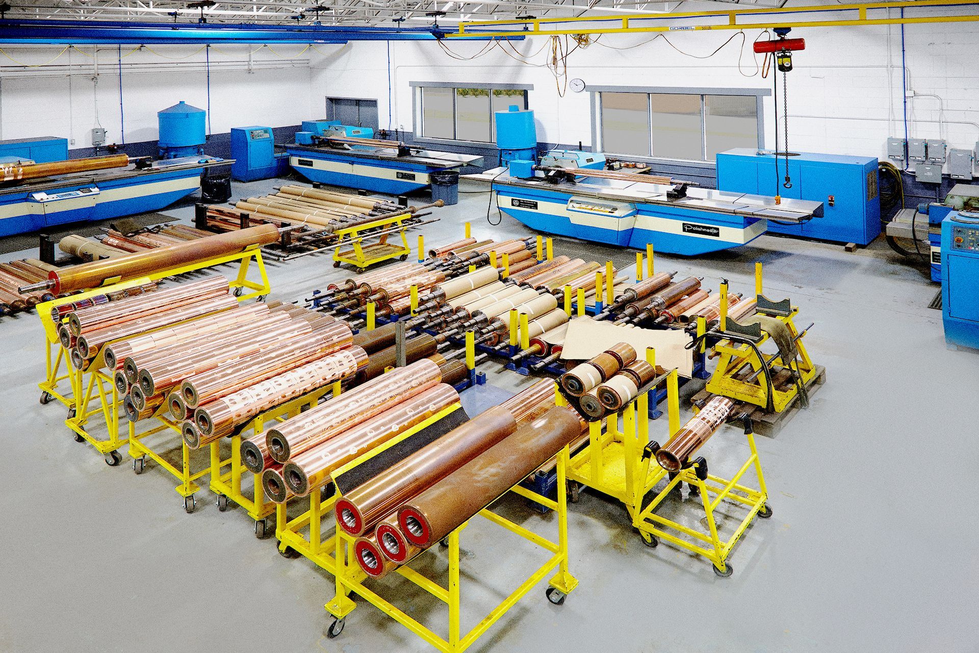 A large warehouse filled with lots of copper pipes and rolls.