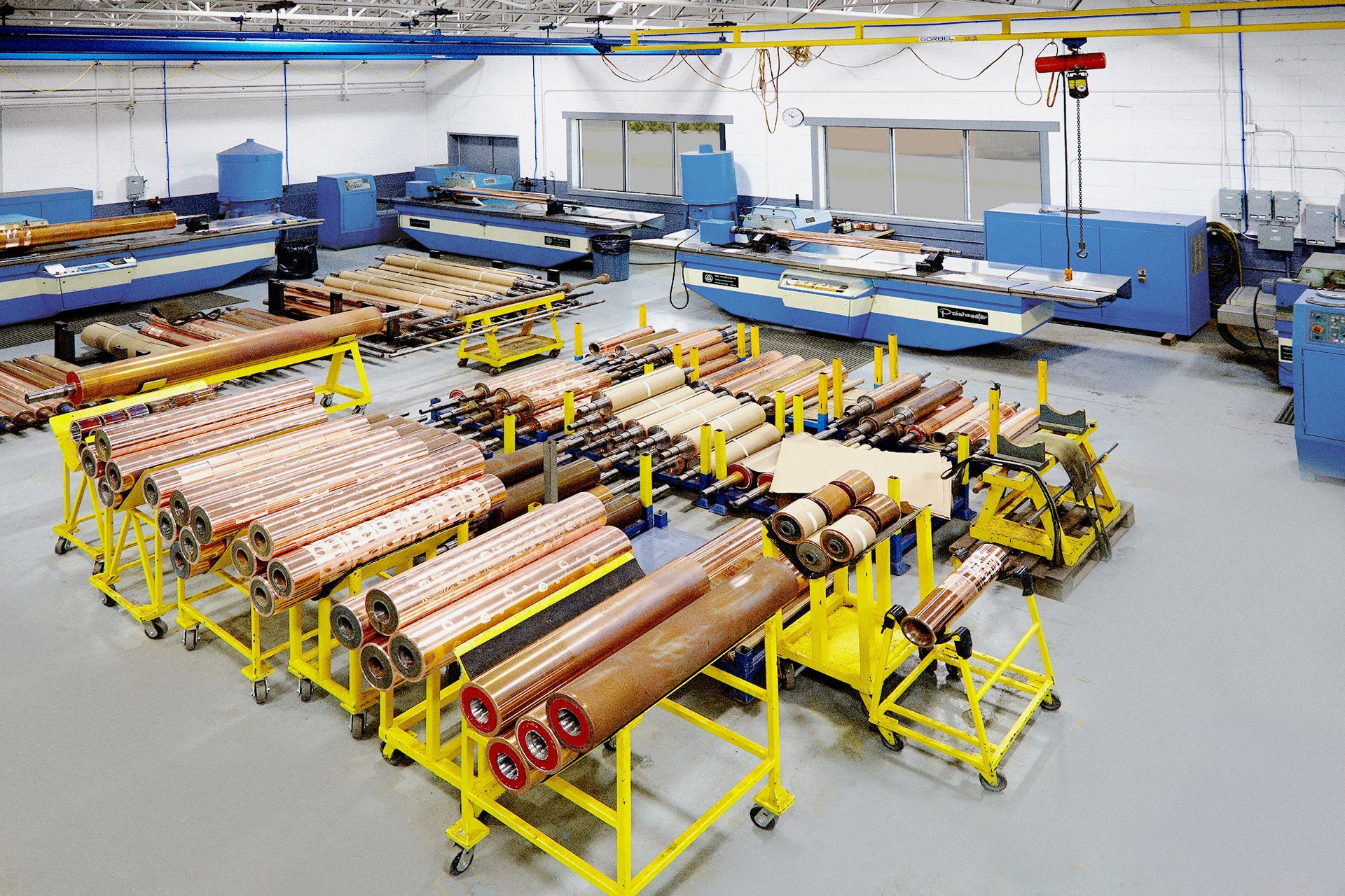 A large warehouse filled with lots of copper pipes and rolls.