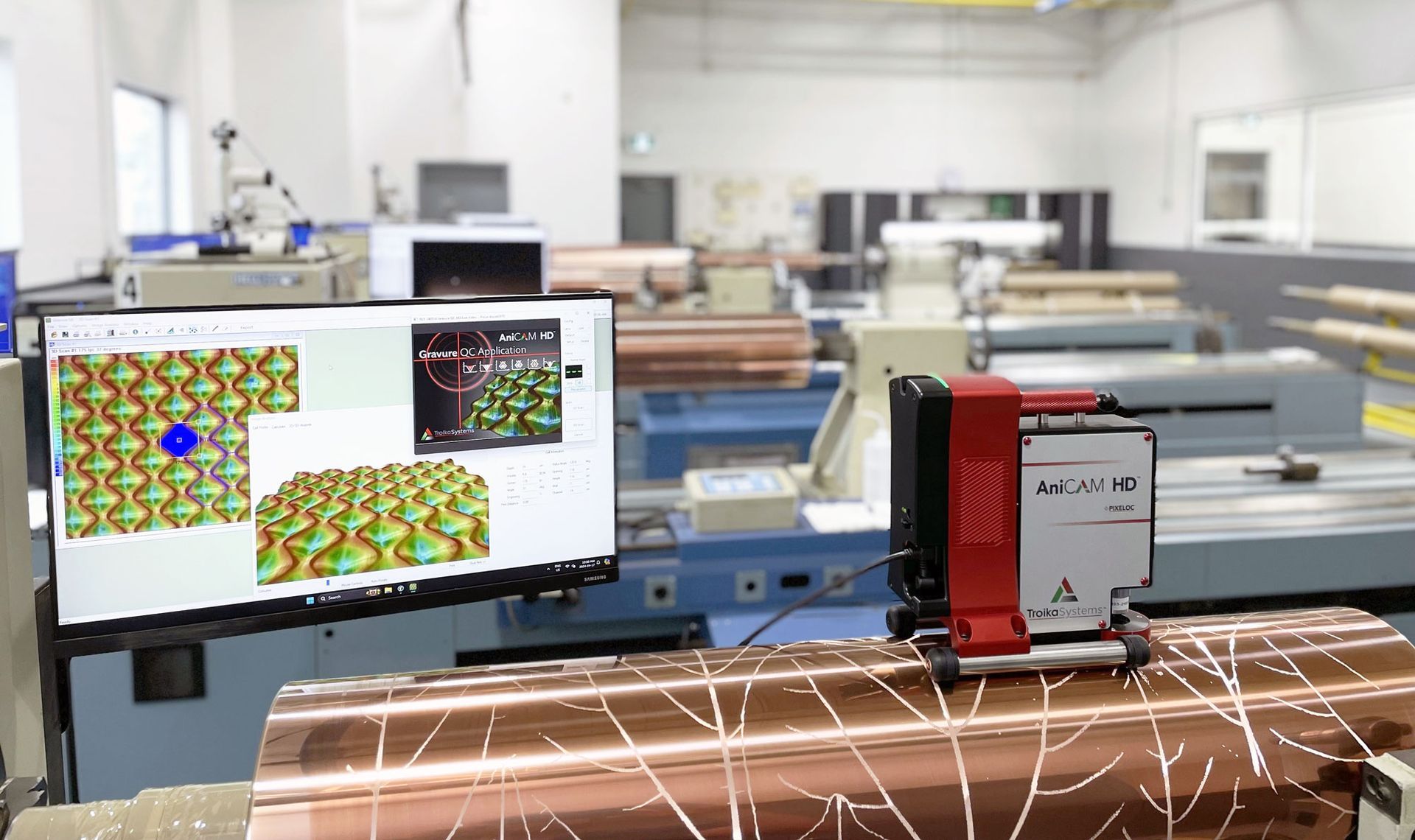 A man is looking at a computer screen in a factory.